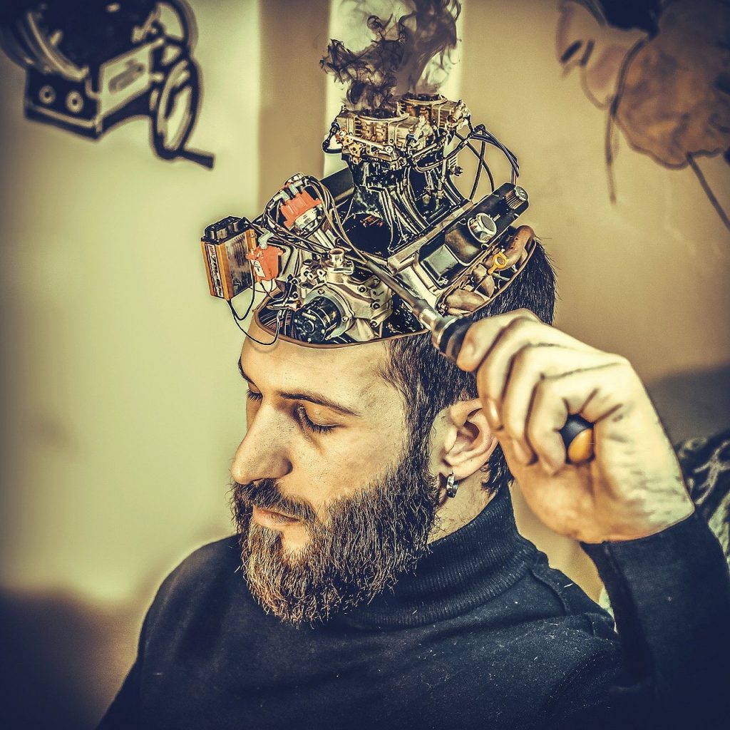 man making changes in his brain which looks like a machine
